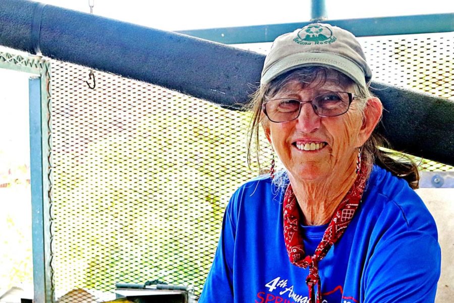 Smiling lady wearing glasses do gardening