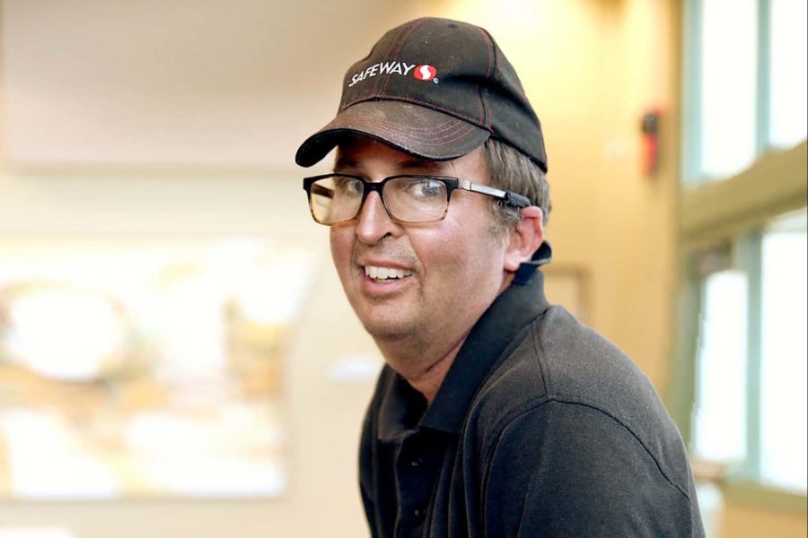 Man wearing glasses working at grocery store