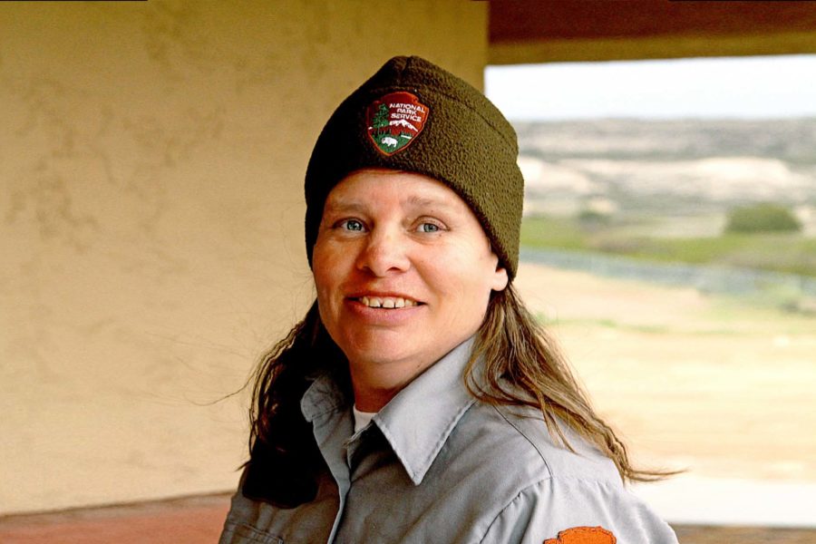 Woman wearing national park service hat smiling