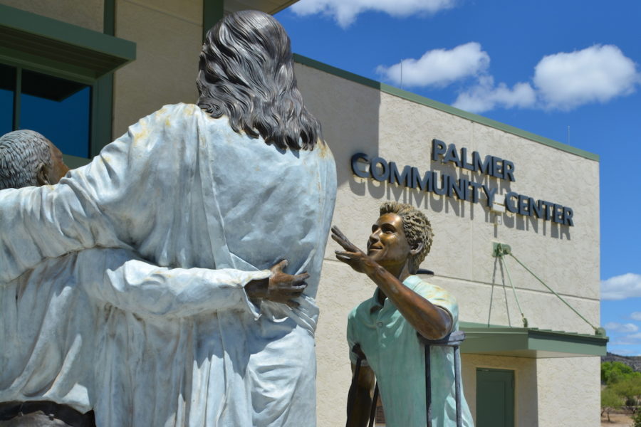 Statue depicting differently abled adults living at Rainbow Acres in AZ, in front of the Palmer Community Center