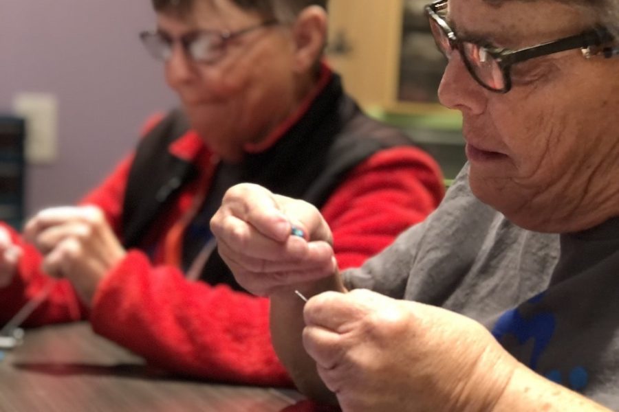 Ranchers working on beading jewelry