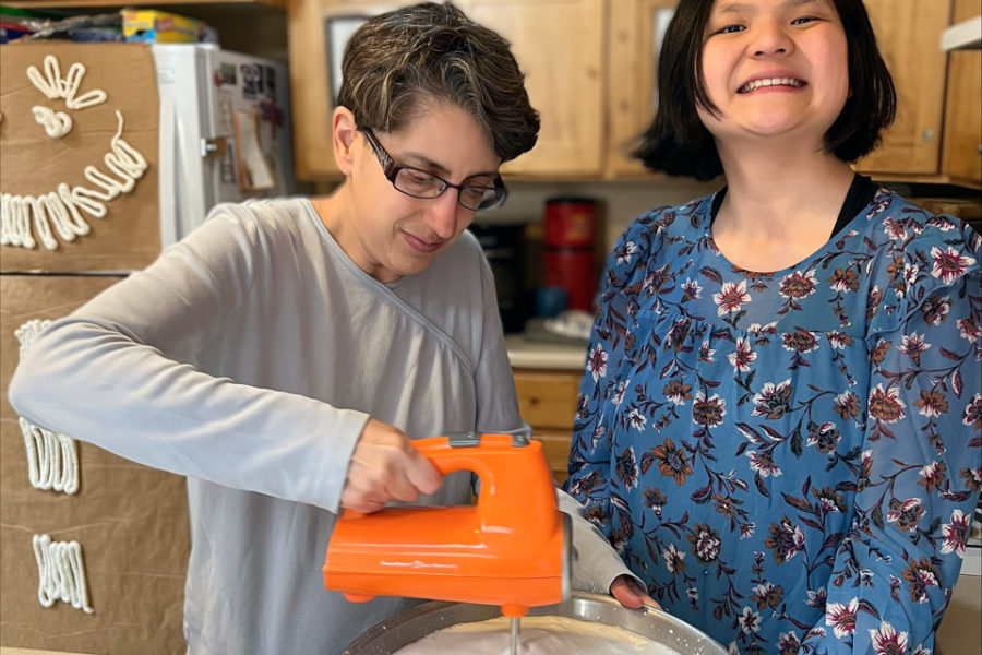 Lady Ranchers cooking in the communal kitchen of their house at Rainbow Acres