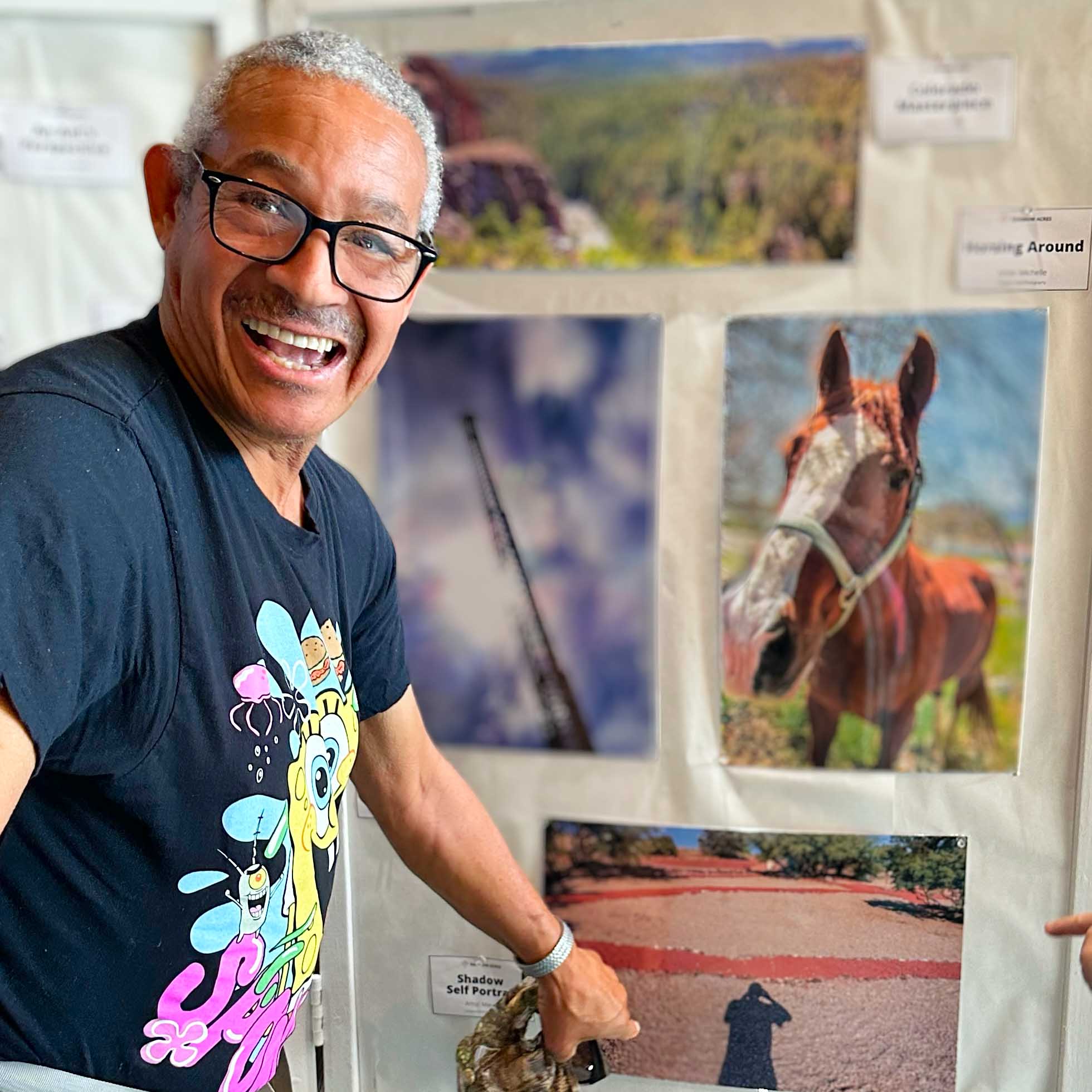 Marcus shows off his photos at the Sedona Library Photography Show for Rainbow Acres