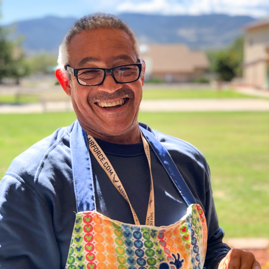 Marcus poses with his camera at Rainbow Acers. for Scholarship Fund.