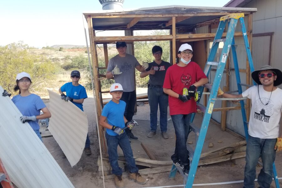 A mission team volunteering at Rainbow Acres, helping with roof repairs