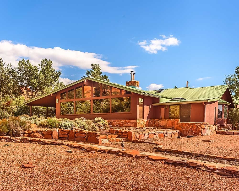 A single story residence with large windows in Sedona, named the Mountain Lodge in the Sedona Lago Gardens living facility for neurodiverse adults.